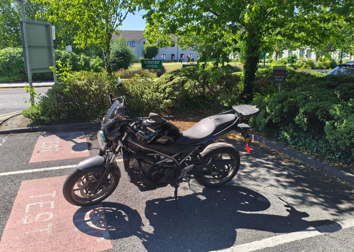 Black Suzuki motorcycle parked and ready for rider training.