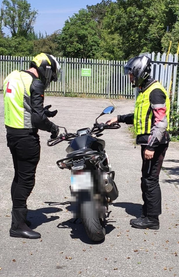 Mick explaining motorcycle controls to a learner.